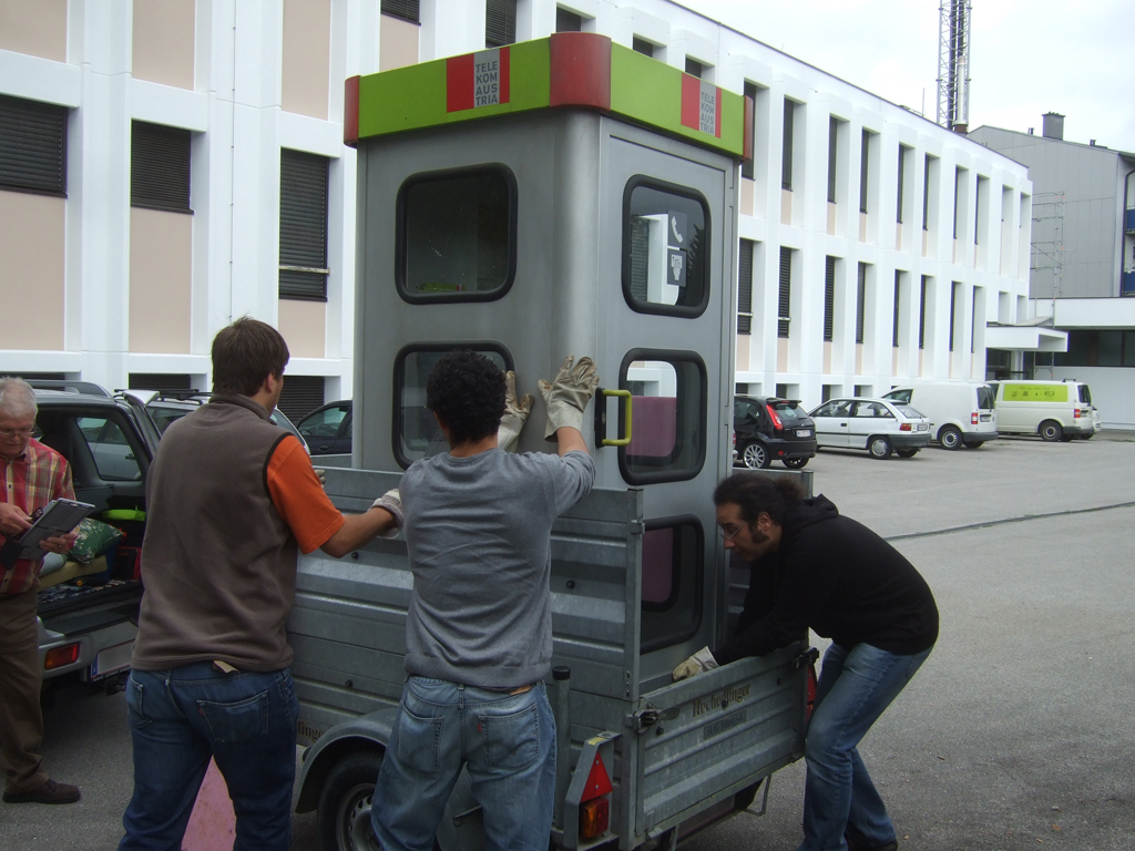 Picking up the telephone booth Picking up the telephone booth